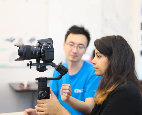 woman holding camera on stabilizer